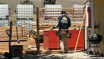 fence contractor building a wooden fence