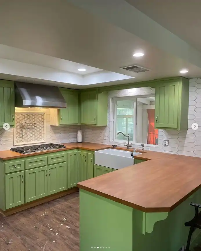 kitchen remodel with green cabinets and wood countertops